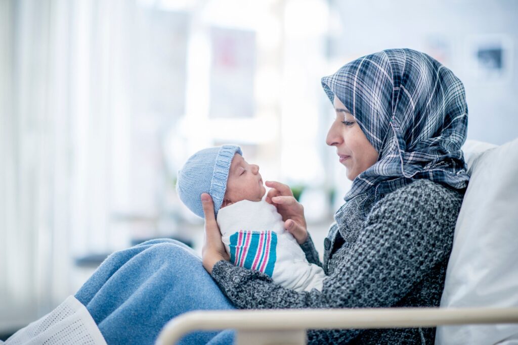 woman in headscarf with new baby